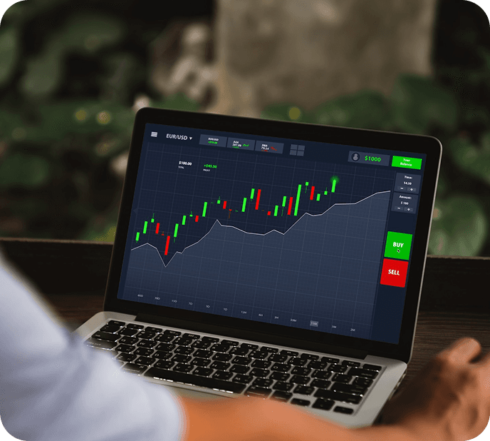 Trader analyzing a candlestick chart on a laptop with EUR/USD trading screen